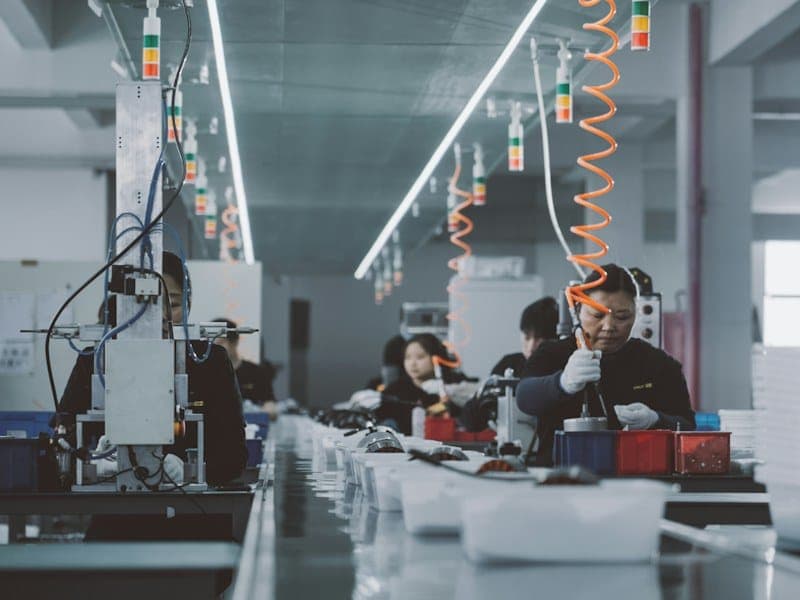 Operators assembling and terminating cable assemblies at the factory bench.